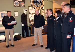 Command Master Chief Jeffrey Dell, Naval Hospital Oak Harbor, reads a letter of appreciation from the PBY Naval Air Museum to Navy volunteers.